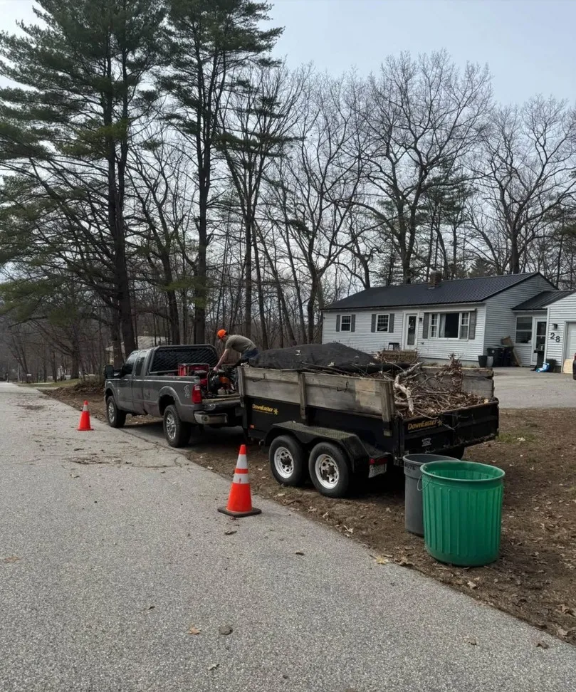 Truck and trailer loaded with brush during a cleanup