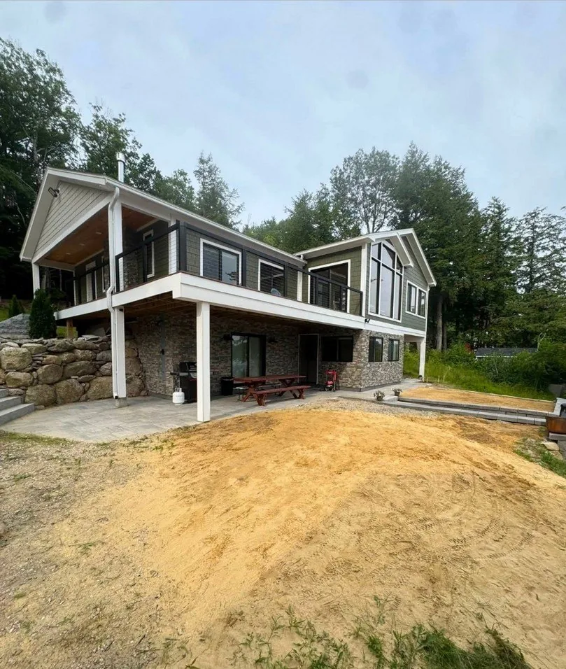 Before the pea stone bed, a bare sandy yard